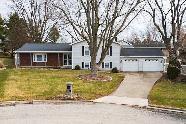 tri-level home featuring a garage and a front lawn