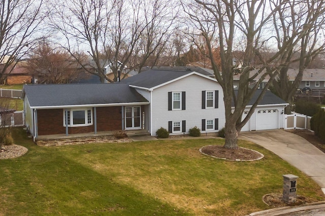 tri-level home with a garage and a front yard