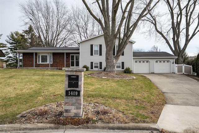 split level home with a front lawn and a garage