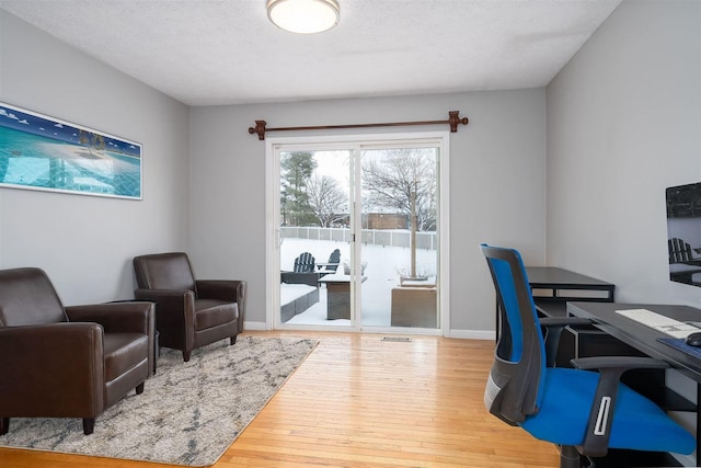 office space with hardwood / wood-style floors and a textured ceiling