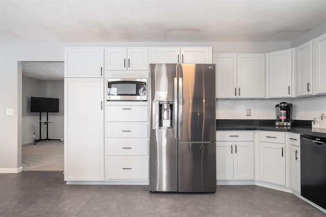 kitchen featuring carpet, a textured ceiling, appliances with stainless steel finishes, tasteful backsplash, and white cabinetry