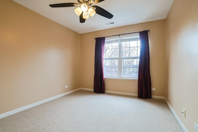 carpeted spare room with ceiling fan