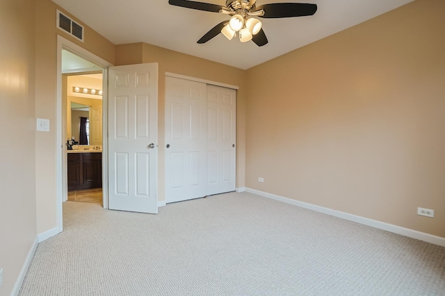 unfurnished bedroom with ceiling fan, a closet, and light colored carpet