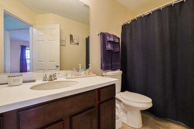 bathroom with tile patterned floors, vanity, and toilet