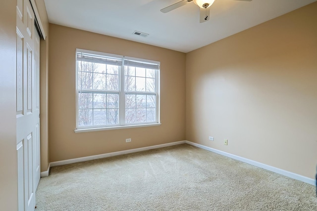 carpeted empty room featuring ceiling fan