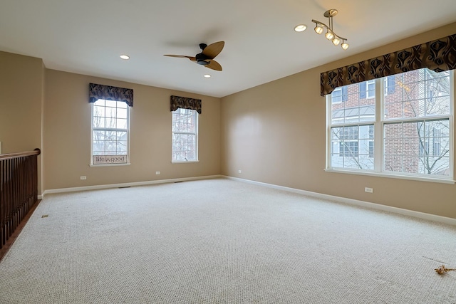 carpeted spare room with ceiling fan