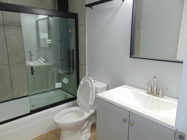 full bathroom featuring tile patterned flooring, vanity, toilet, and enclosed tub / shower combo