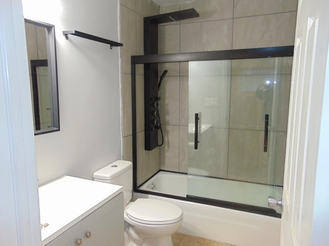 full bathroom with tile patterned floors, vanity, bath / shower combo with glass door, and toilet