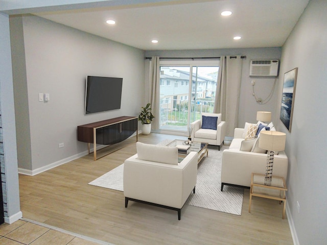 living room featuring a wall unit AC and light hardwood / wood-style flooring