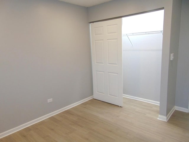 unfurnished bedroom featuring a closet and light hardwood / wood-style flooring