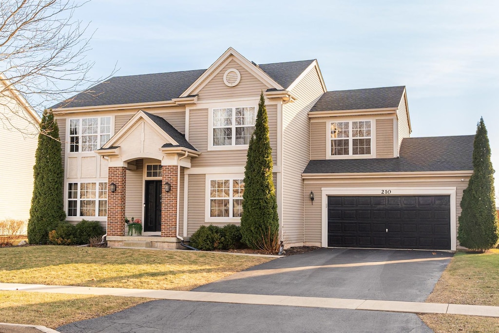 view of front facade with a garage and a front lawn