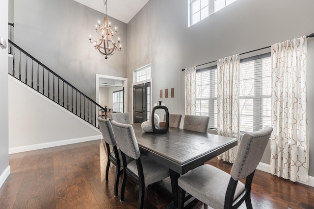 dining space featuring a chandelier, a high ceiling, and dark wood-type flooring