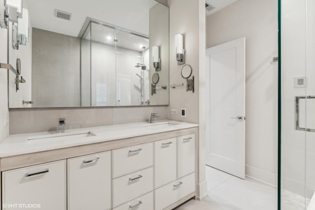 bathroom with tile patterned flooring, vanity, and a shower with door