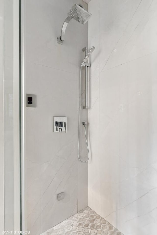 bathroom with tiled shower