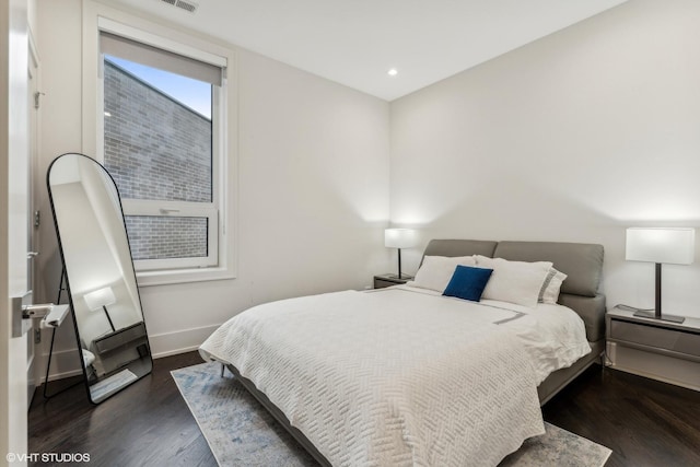 bedroom with dark wood-type flooring