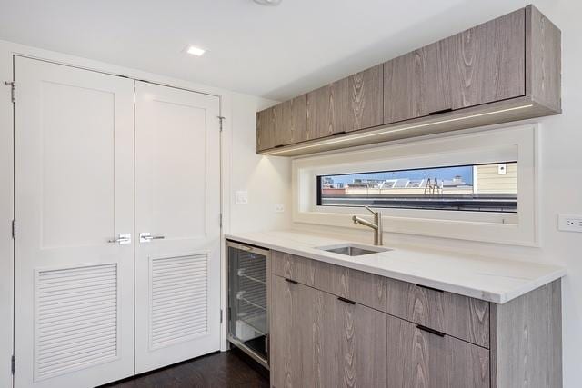 kitchen featuring wine cooler and sink