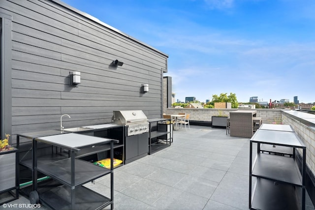 view of patio with a grill, exterior kitchen, and sink