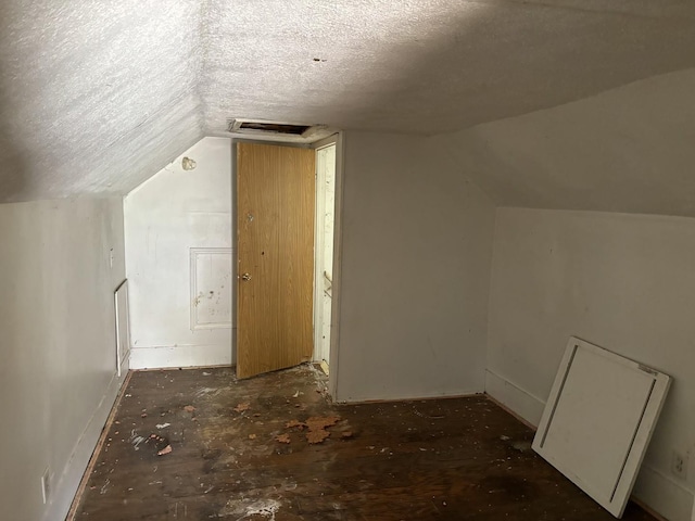 bonus room featuring vaulted ceiling and a textured ceiling