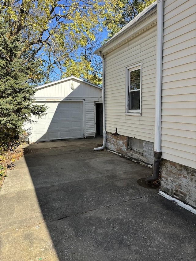 exterior space with an outbuilding and a garage