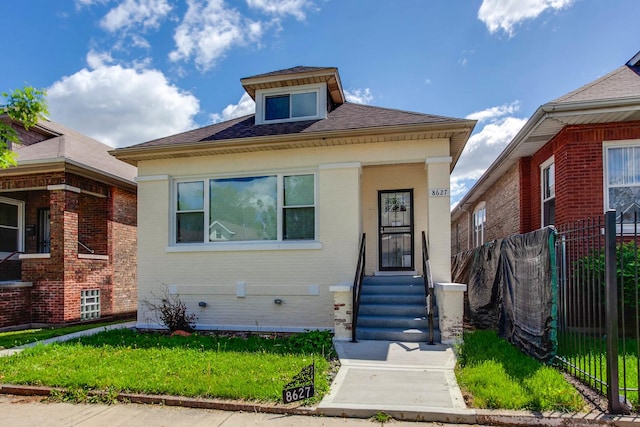 bungalow-style home with a front yard