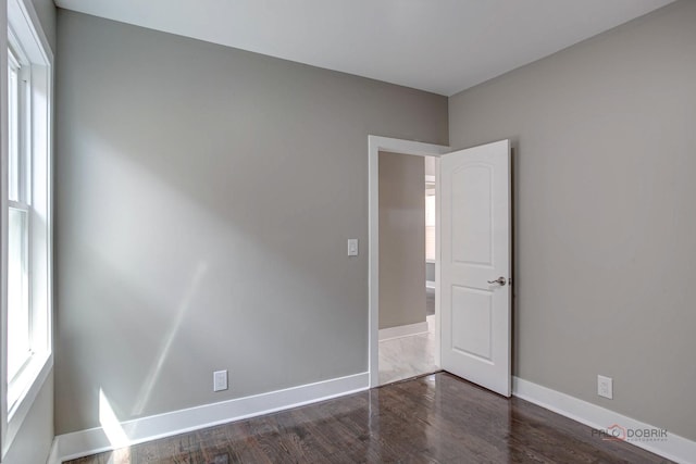 empty room featuring dark wood-type flooring