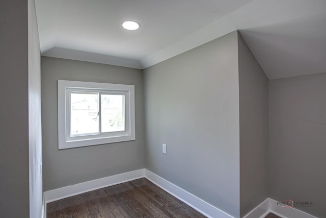 bonus room featuring dark hardwood / wood-style floors and vaulted ceiling