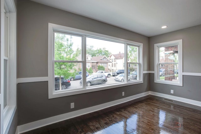 unfurnished room with dark hardwood / wood-style floors