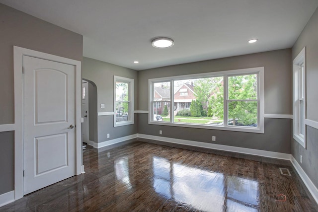 unfurnished room featuring dark wood-type flooring