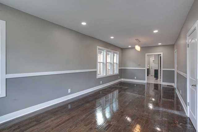 spare room with dark wood-type flooring