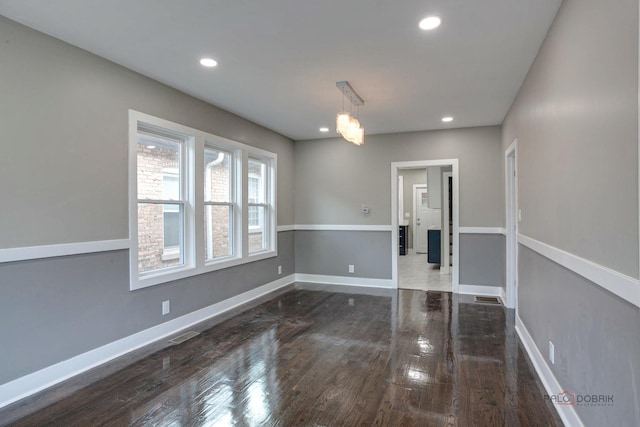 unfurnished dining area with dark wood-type flooring