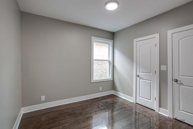 spare room with dark hardwood / wood-style floors