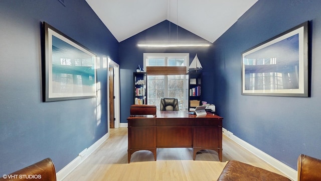 office with light hardwood / wood-style floors and vaulted ceiling