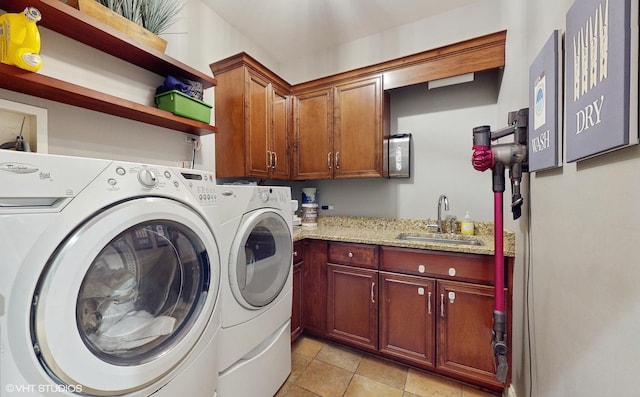 laundry room with cabinets, independent washer and dryer, sink, and light tile patterned floors