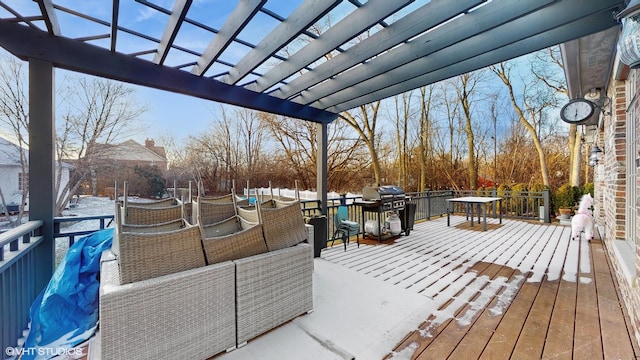 snow covered deck featuring a pergola