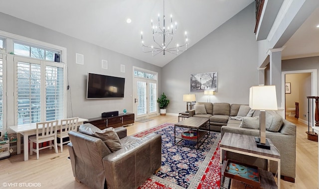 living room featuring light wood-type flooring, high vaulted ceiling, and an inviting chandelier