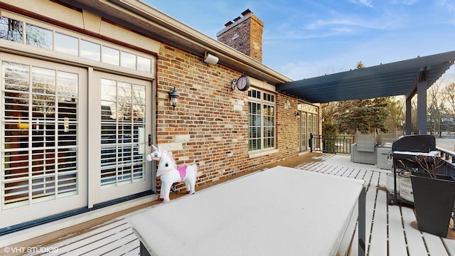 wooden terrace featuring a grill