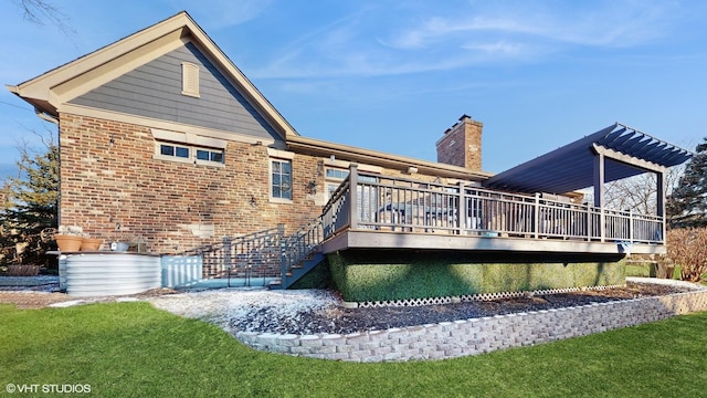 rear view of house featuring a lawn and a wooden deck