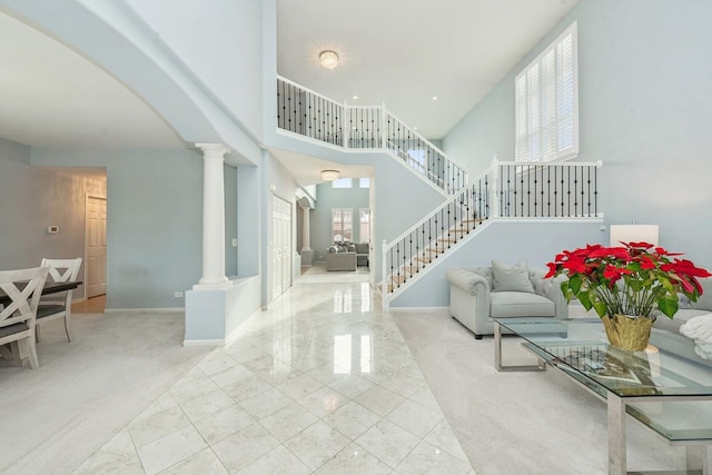 entrance foyer featuring a high ceiling and a wealth of natural light