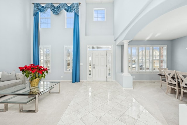 carpeted entrance foyer featuring decorative columns