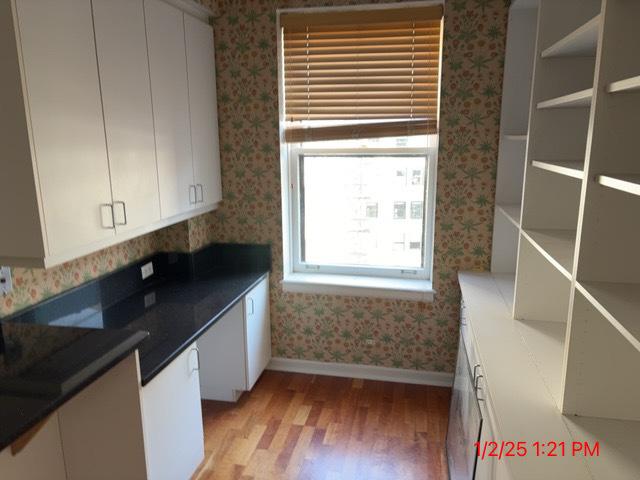 kitchen with light hardwood / wood-style floors and white cabinetry