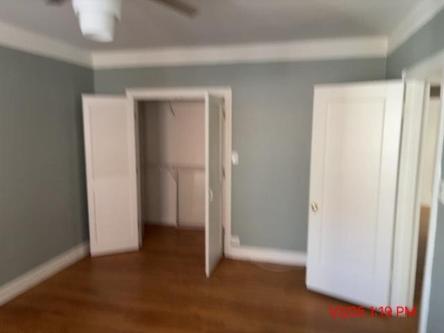 unfurnished bedroom with dark hardwood / wood-style flooring and a closet