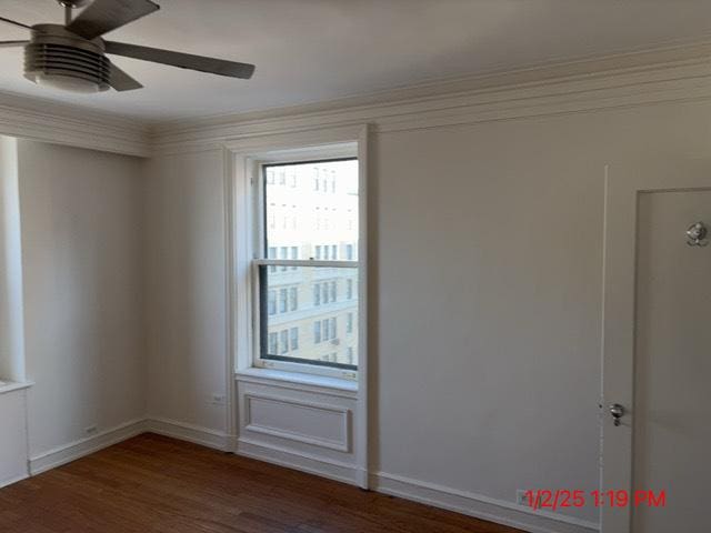 empty room with ceiling fan and dark hardwood / wood-style floors