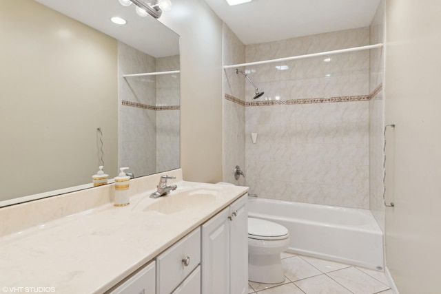 full bathroom featuring tile patterned flooring, vanity, toilet, and tiled shower / bath