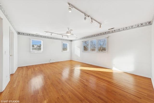 spare room featuring light hardwood / wood-style flooring and ceiling fan