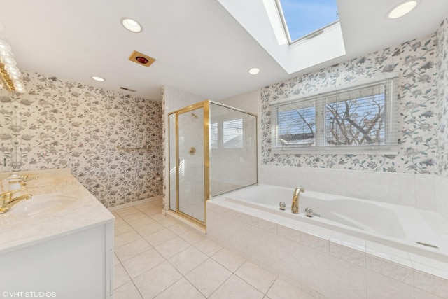 bathroom featuring tile patterned flooring, vanity, independent shower and bath, and a skylight