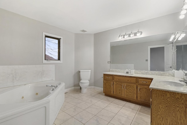 bathroom featuring tile patterned flooring, vanity, a tub to relax in, and toilet