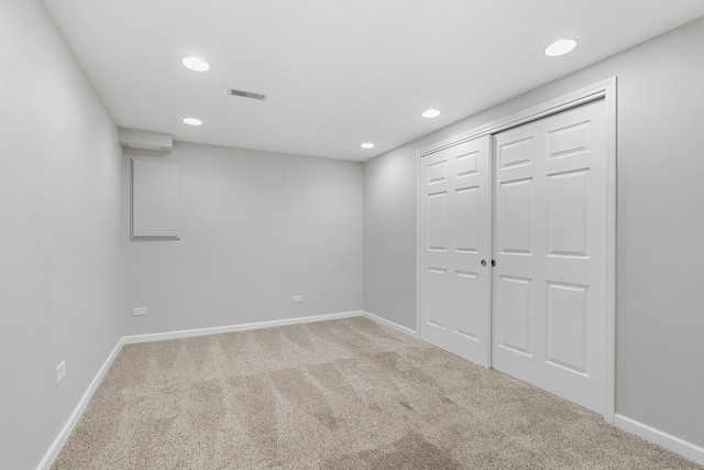 interior space with light carpet and a closet