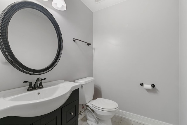 bathroom featuring tile patterned floors, vanity, and toilet