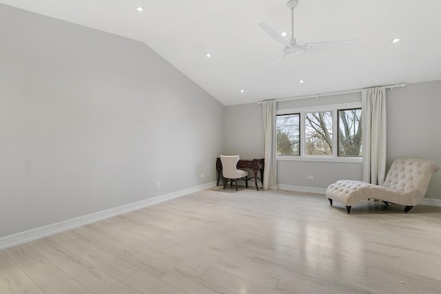 living area featuring ceiling fan, lofted ceiling, and light wood-type flooring