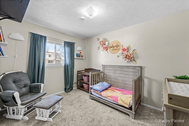 bedroom featuring a textured ceiling and carpet flooring